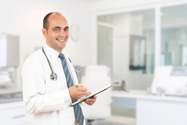 Médico Masculino Com Estetoscópio Segurando Caderno Smiling Médico Masculino Preenchendo — Fotografia de Stock