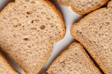 Beyaz bir tabakta buğday unundan pişirilmiş kahverengi ekmek dilimleri.