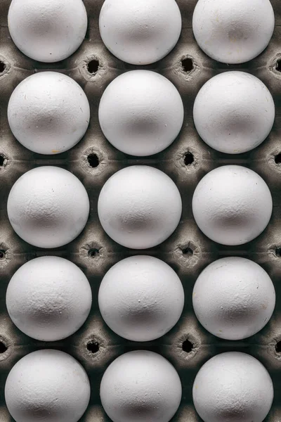 Organic eggs arranged in a green egg box