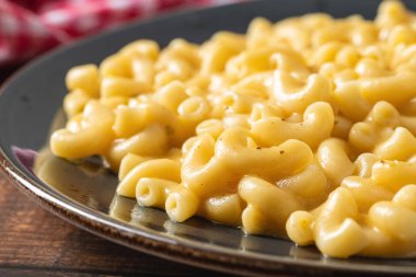Delicious Mac n Cheese or macaroni and cheese on a black porcelain plate