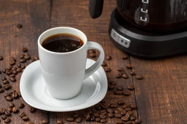 Filter coffee brewed in a filter coffee machine in a white porcelain cup