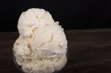 White cream flavored ice cream. Served in a glass bowl. Gelato enjoyed all over the world. Gourmet photography of frozen desserts.