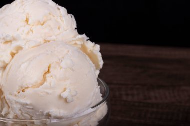 White cream flavored ice cream. Served in a glass bowl. Close-up gastronomic photography.