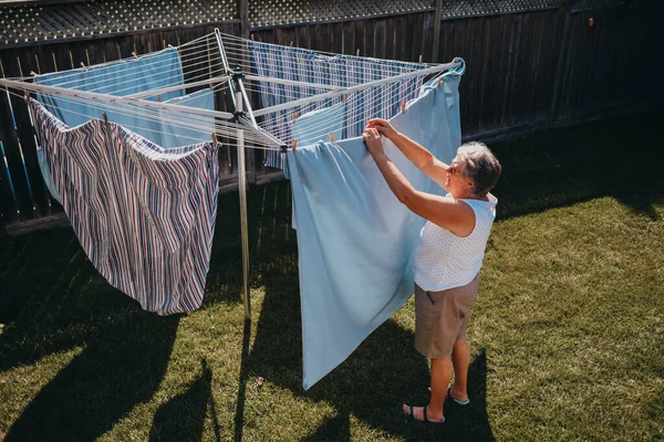 Senior Woman Hanging Laundry Outdoor Clothesline — Stock Photo, Image