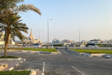 Cityscape old town of Doha, Qatar with Al Fanal building and Qatar Islamic Cultural Center against blue sky