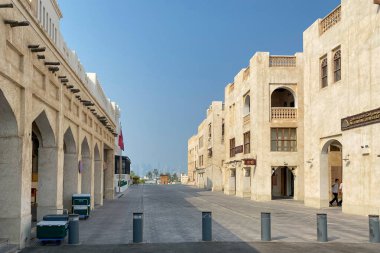 Doha, Qatar  October 5, 2019: Old town Souq Waqif, Doha Qatar with modern skyline in the background against blue sky.