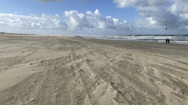 Hollanda, Kijkduin 'deki Kuzey Denizi sahili manzaralı bulutlu mavi gökyüzüne karşı