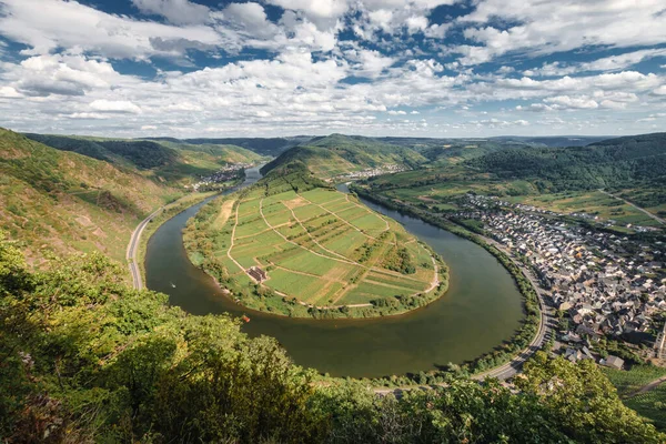 Landscape and scenic view from Calmont hiking trail to Moselle loop (germ. Moselschleife) and the villages of Ediger-Eller, Neef and Bremm (left to right), Germany against blue sky