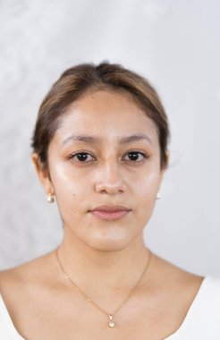 Kameraya poz veren bale elbiseli genç bir kadın..