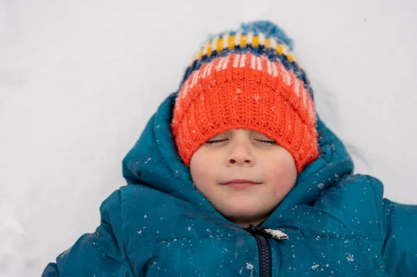 Little Boy Knit Cap Making Snow Angels — Fotografia de Stock