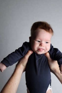 Father holding his sad son in his arms