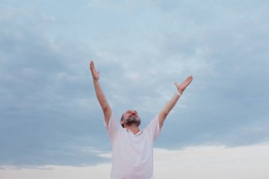 Happy Senior man with hands up outside