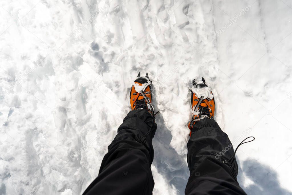 Snow crampones on a orange shoes