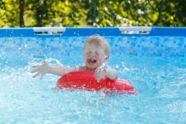 Blond Boy Pool Splashes Water Laughs — Stock Photo, Image