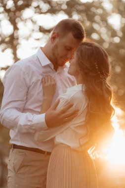 Loving wedding couple outdoor in the rays of the sunset
