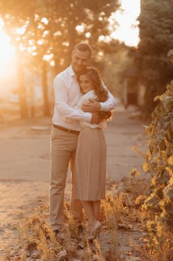 Loving wedding couple outdoor in the rays of the sunset