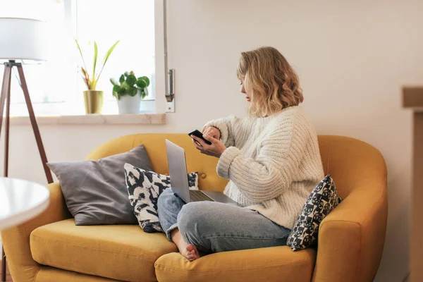 Woman Sweater Sitting Couch Using Smartphone Laptop — Foto Stock