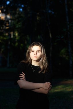 Koyu renk elbiseli genç kız. Güneşten yanıyor.