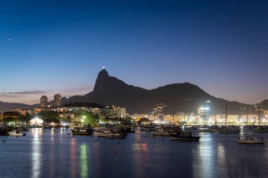 Beautiful sunset view to ocean, boats and mountain silhouettes in Rio de Janeiro, Brazil