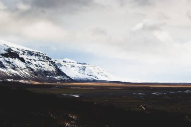 Snow Covered Icelandic Mountains on a Cloudy Day