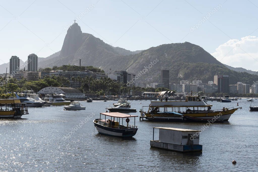 Beautiful view to boats parked on ocean bay and Corcovado Mountain on the back, Rio de Janeiro, Brazil