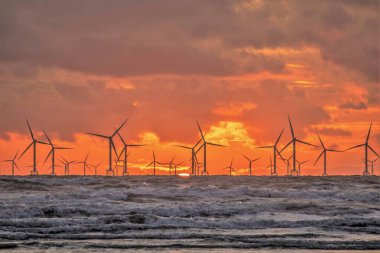 UK Weather:Sunset over the distant Walney Offshore Windfarm. clipart