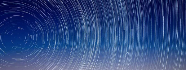 Meteor streak across star trails around Polaris