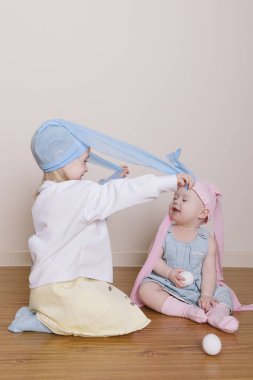 İki kız kardeş Paskalya tavşanı oynuyor.