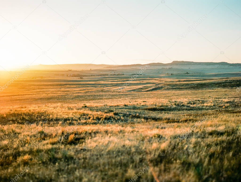 View of Grassy Rolling Hills in Colorado At Sunset