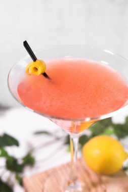 Açık arkaplanda limonlu portakallı martini