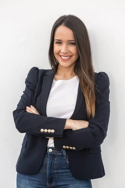 Optimistic brunette with folded arms