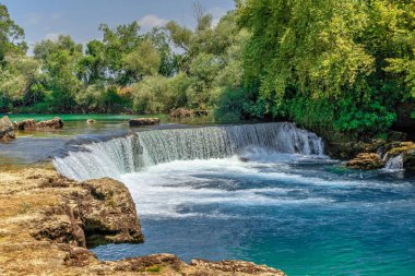 Güneşli bir yaz gününde Türkiye 'nin Antalya ilinde Manavgat şelalesi ve nehri