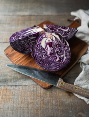 Masadaki tahta kesme tahtasında dilimlenmiş kırmızı lahana başı..