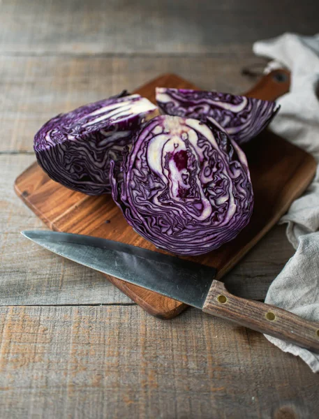 Masadaki tahta kesme tahtasında dilimlenmiş kırmızı lahana başı..