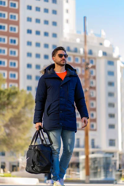 attractive young man walking around the city