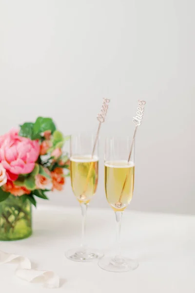 两杯香槟酒后面的花朵 — 图库照片