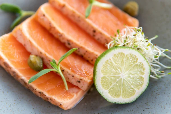 Red Fish Slices Plate Lime Wedges Micro Greens — Stockfoto