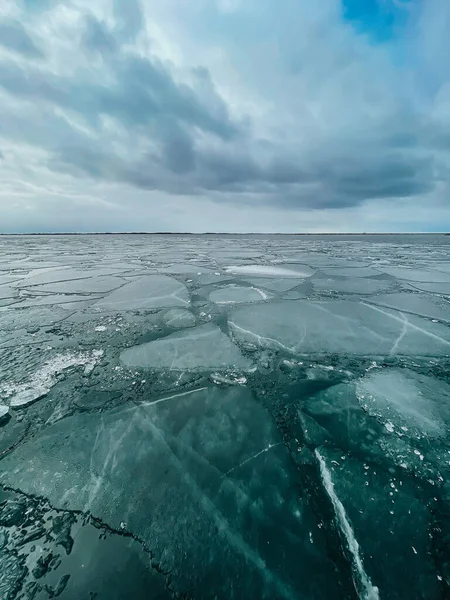 Ice breaking up on Lake Ontario on a cloudy spring day in Canada.