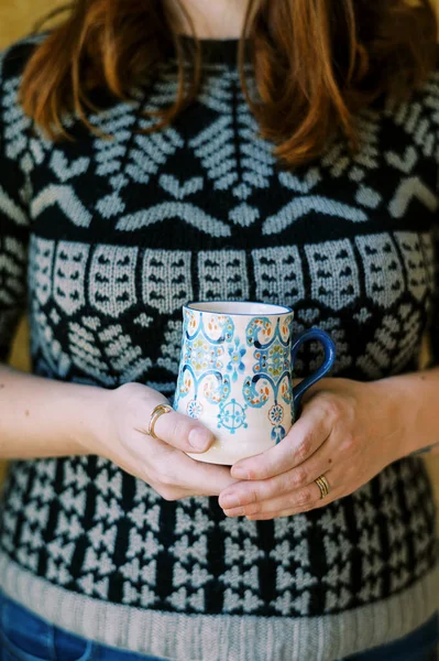 woman holding a custom made coffee cup in her hands