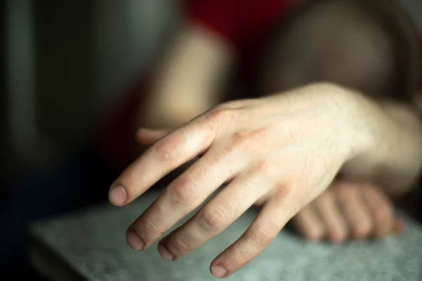 Hand of sleeping person. Guy fell asleep sitting down. Hand of drunk guy.