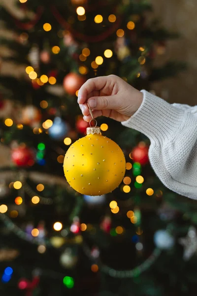Child Holding Bauble Front Christmas Tree Home — Stockfoto