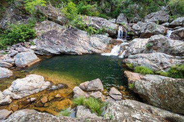 View to beautiful wild river pool on green area in Chapada dos Veadeiros, Gois State, Central Brazil 