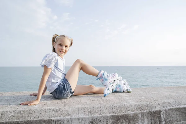 Girl Roller Skates Sitting Seashore —  Fotos de Stock