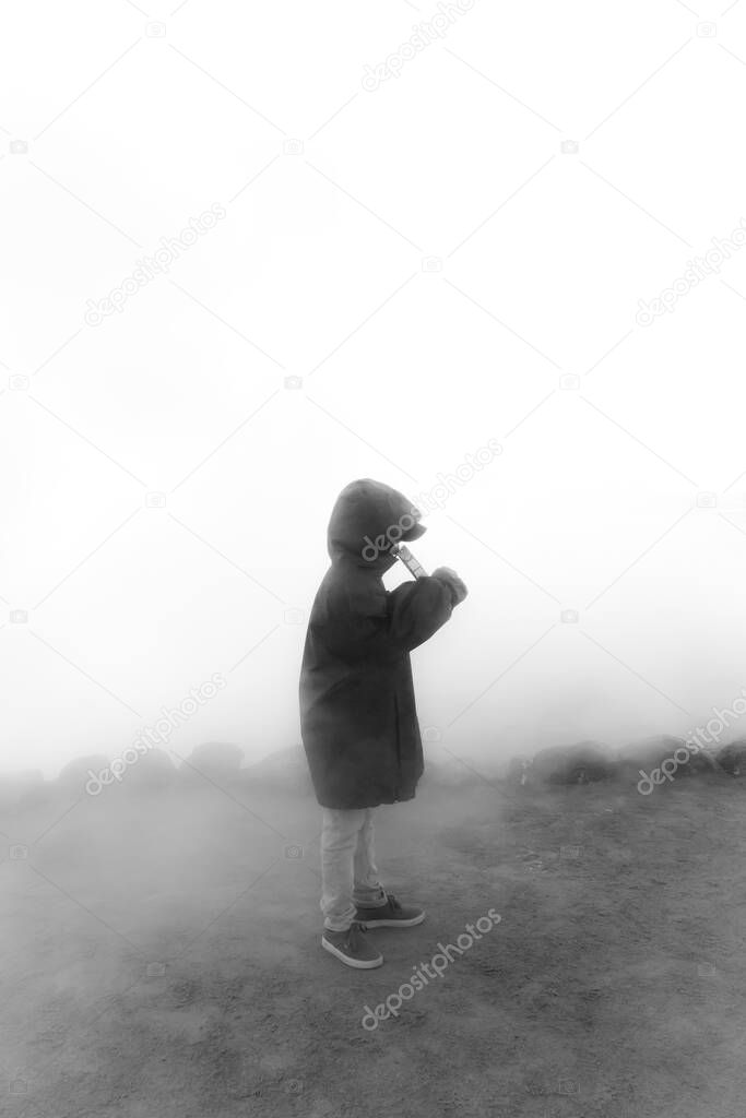 silhouette boy in heavy fog