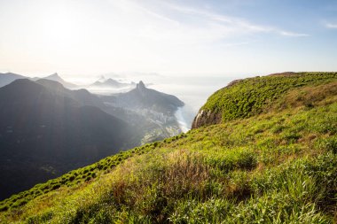 Beautiful view to green mountains, city and rainforest from Pedra da Gavea, Tijuca National Park, Rio de Janeiro, Brazil