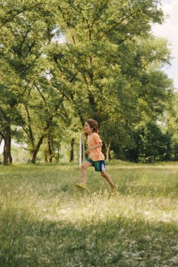 Kid playing outdoors, sport summer day activity
