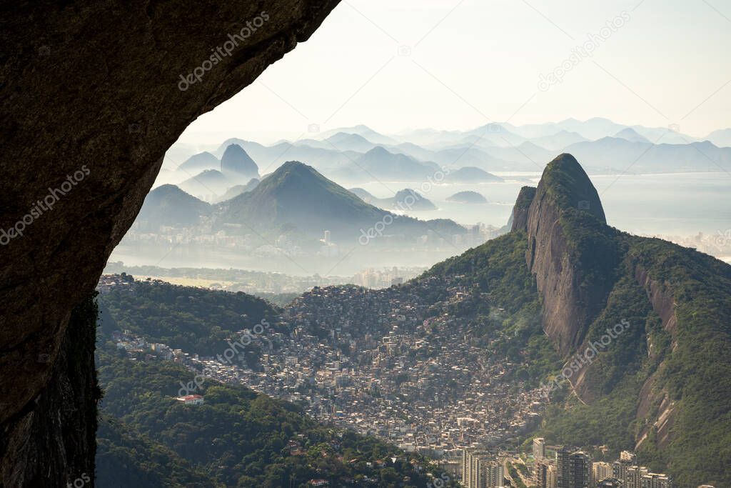 Beautiful view to green mountains, city and rainforest from rocky Pedra da Gavea, Tijuca National Park, Rio de Janeiro, Brazil