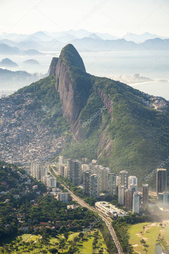 Beautiful view to green mountains, city and rainforest from Pedra da Gavea, Tijuca National Park, Rio de Janeiro, Brazil