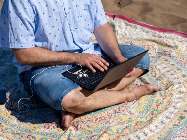 Man on vacation making a video call from the beach