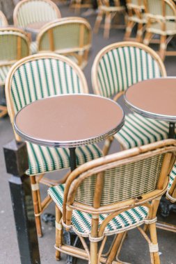 Green and ivory rattan French cafe chairs in Paris, France